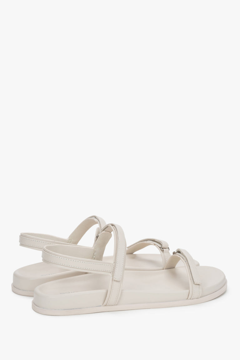 Side profile of women's off-white sandals, showing the flat sole and genuine leather straps.