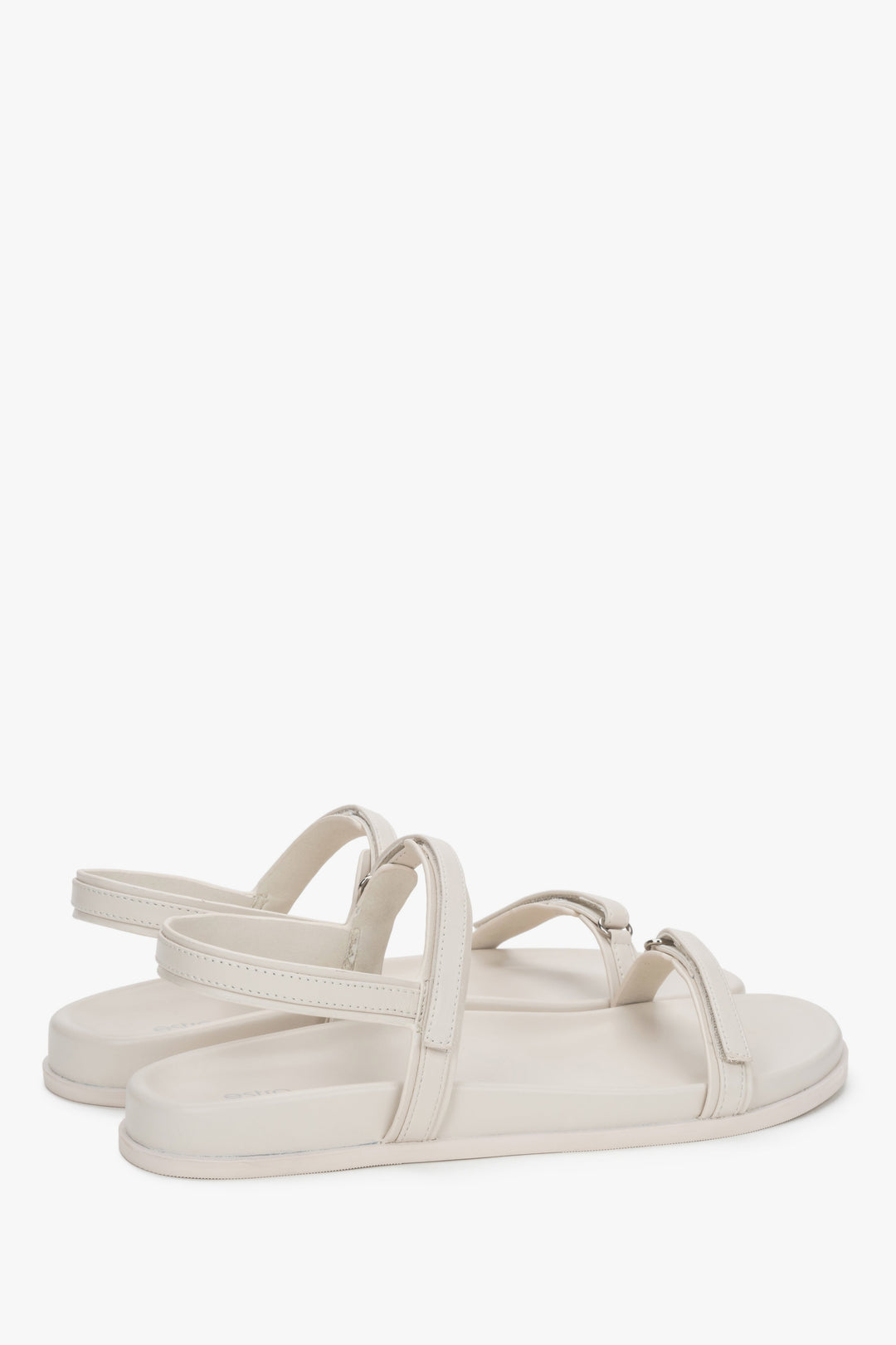 Side profile of women's off-white sandals, showing the flat sole and genuine leather straps.