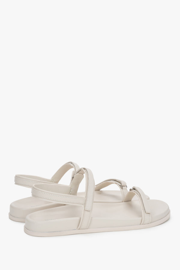 Side profile of women's off-white sandals, showing the flat sole and genuine leather straps.