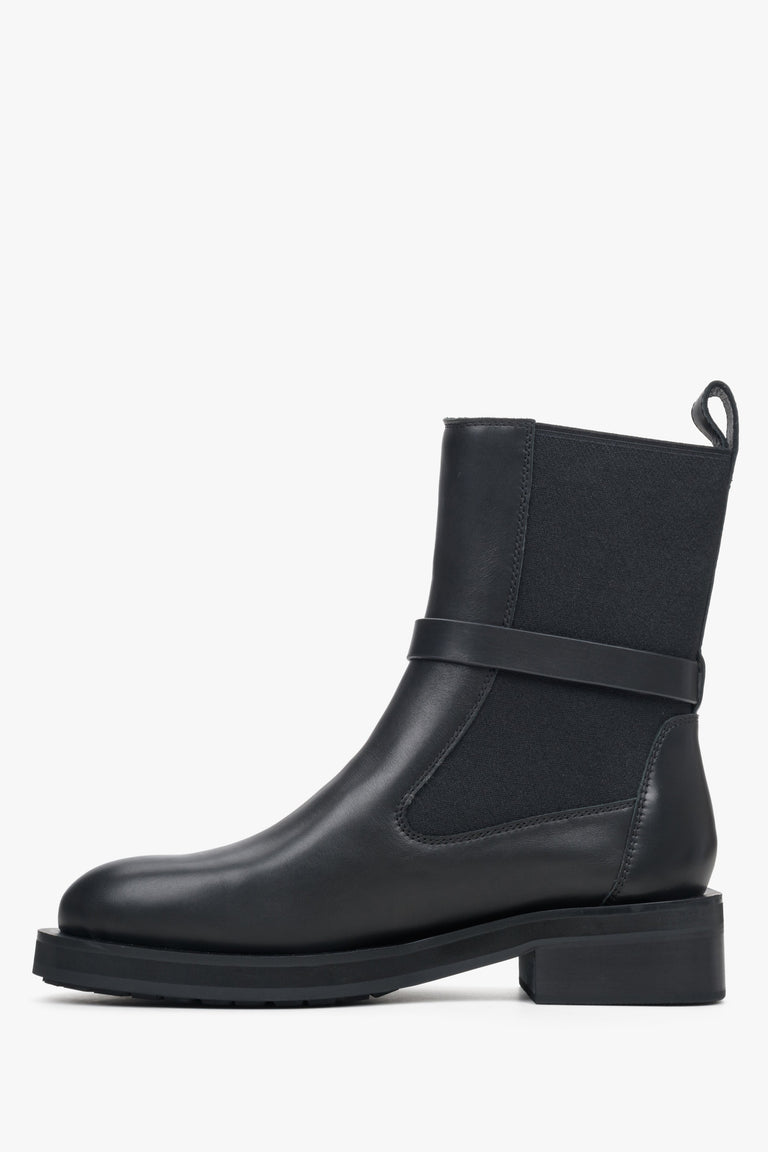 Women's black leather ankle boots with decorative strap by Estro - shoe profile.