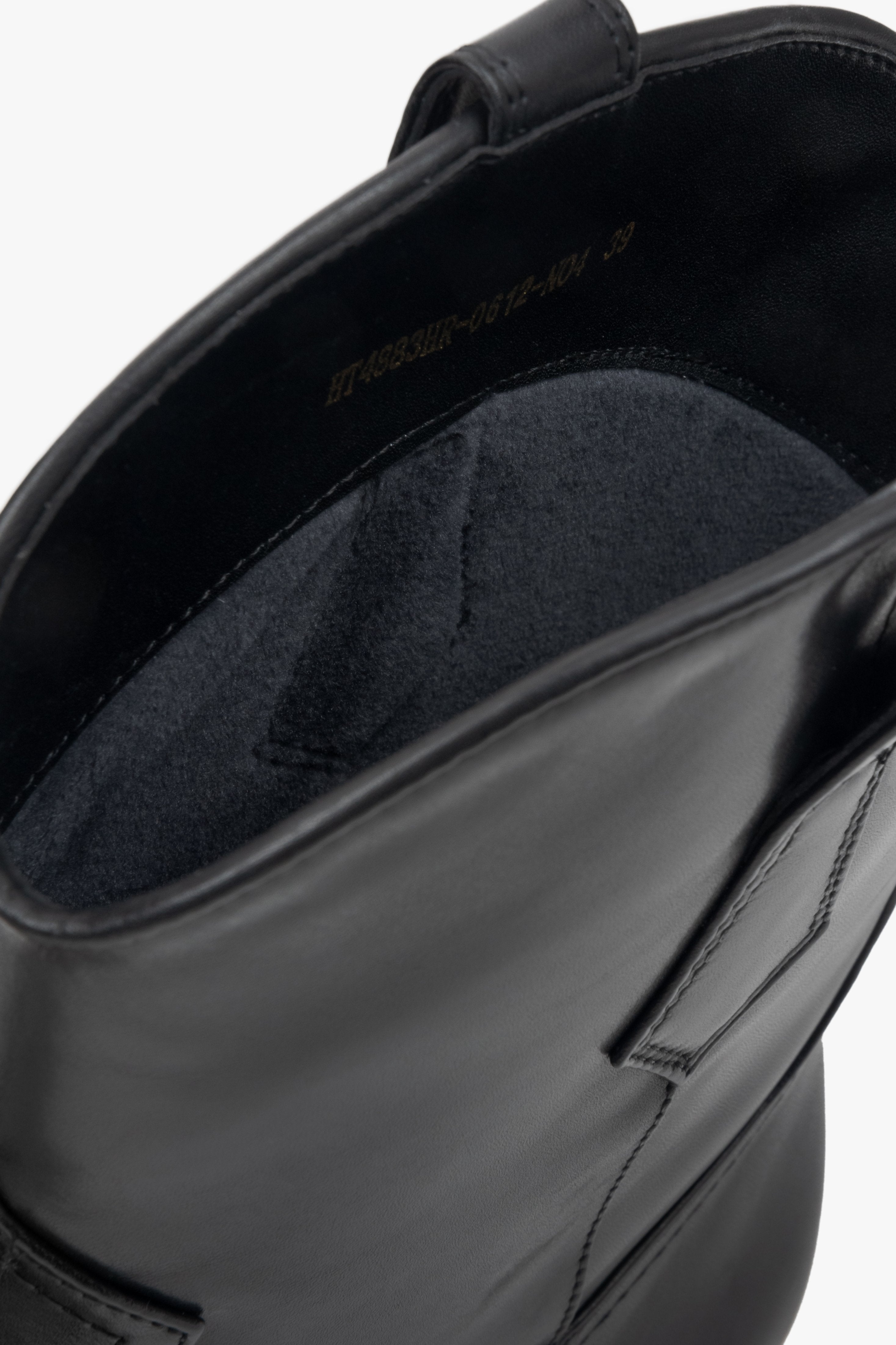 Black leather ankle boots for women by Estro - close-up of the side line and heel of the shoes.