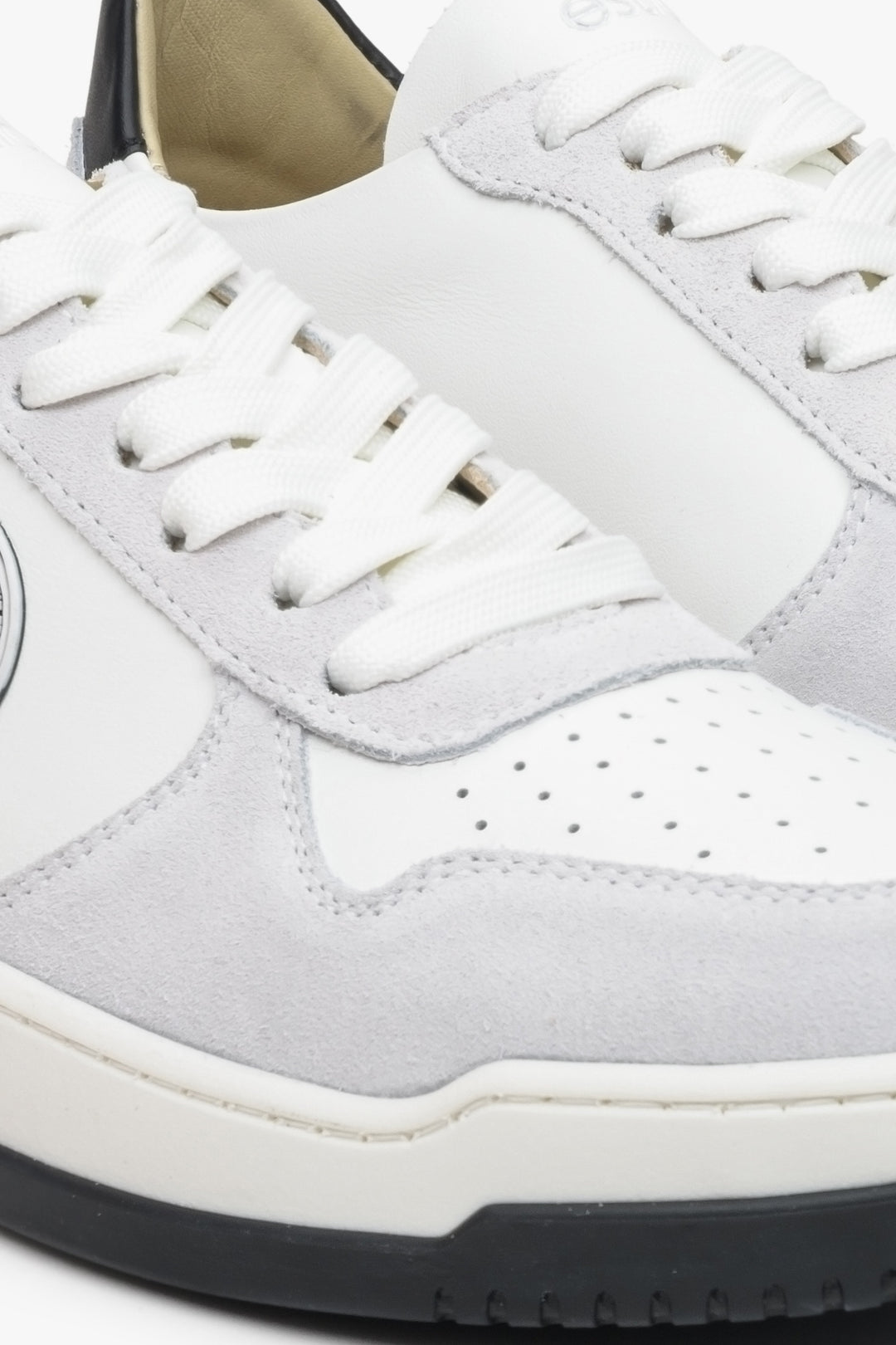 Leather women's sneakers by Estro in grey and white color with laces - close-up on the details.