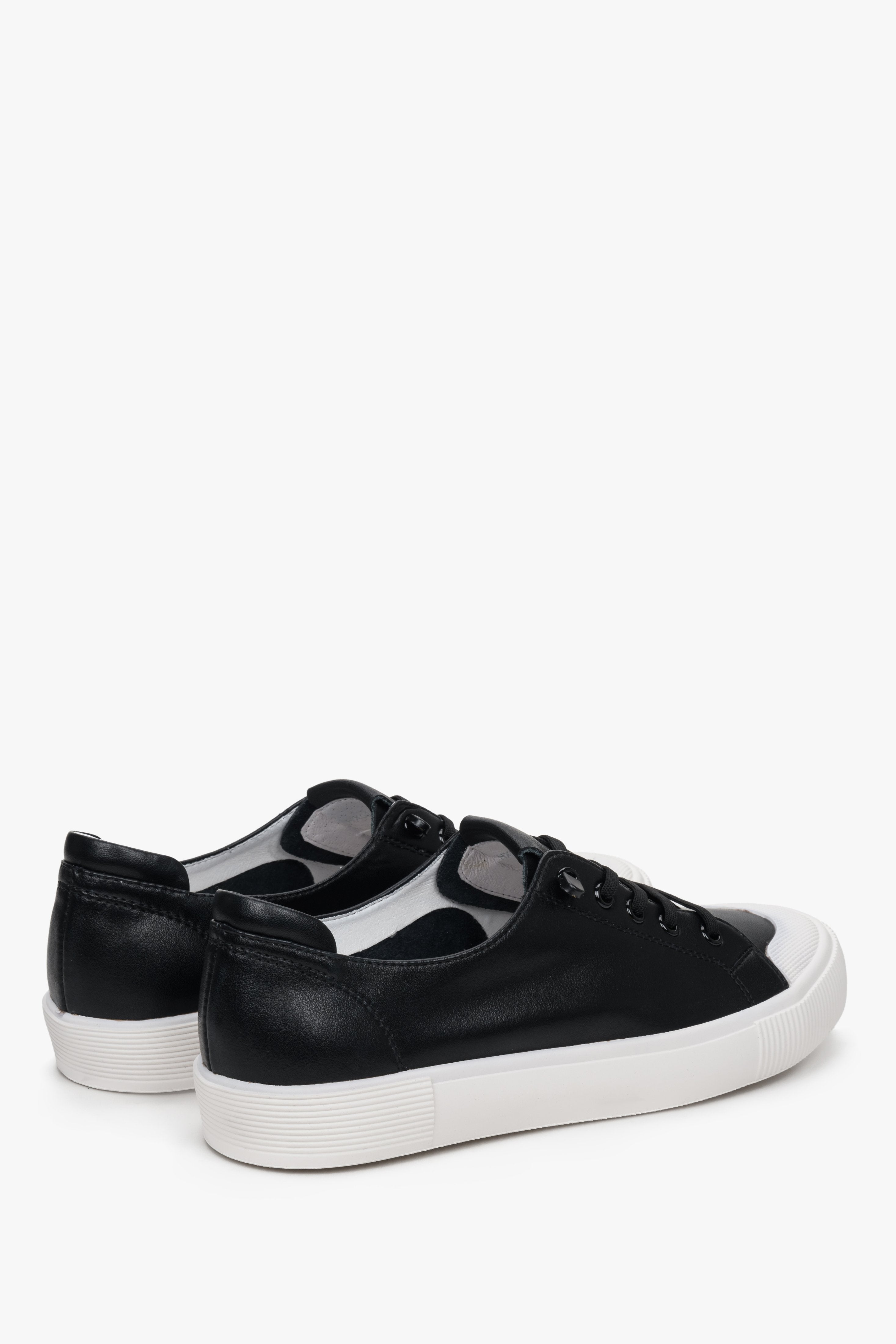 Women's lace-up black sneakers by Estro - close-up on the side seam and heel.