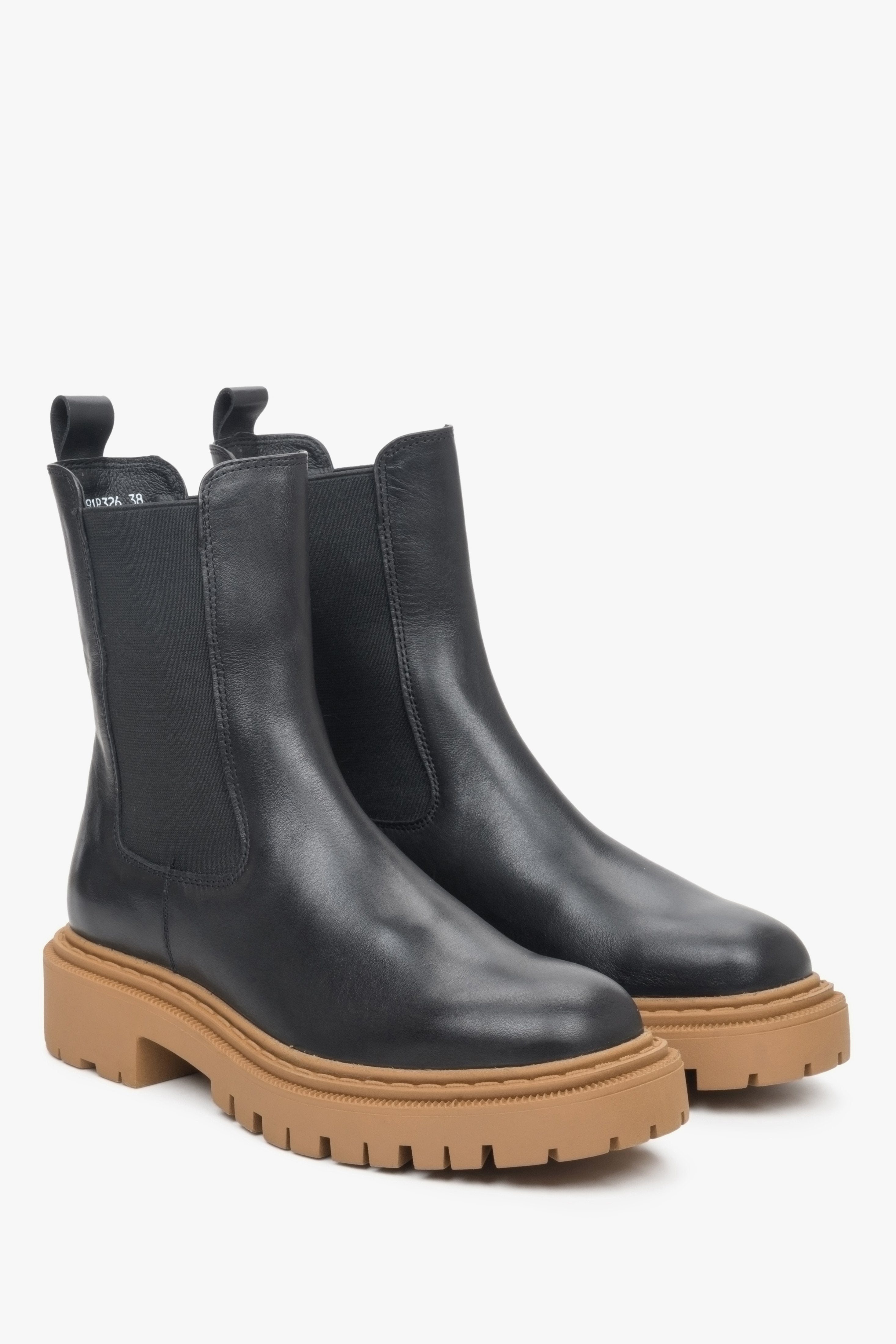 Women's leather chelsea boot in black with brown chunky sole.