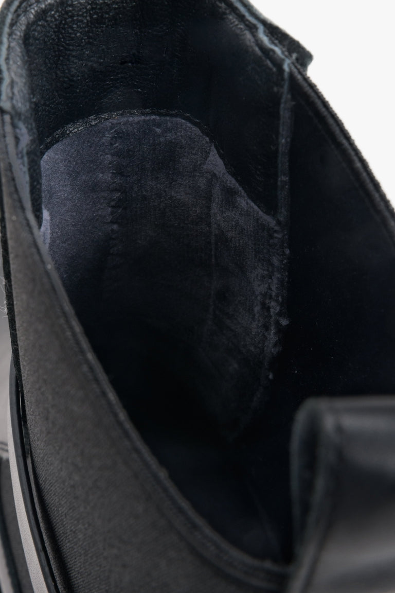 Women's black leather ankle boots by Estro with decorative strap - close-up on the interior of the model.