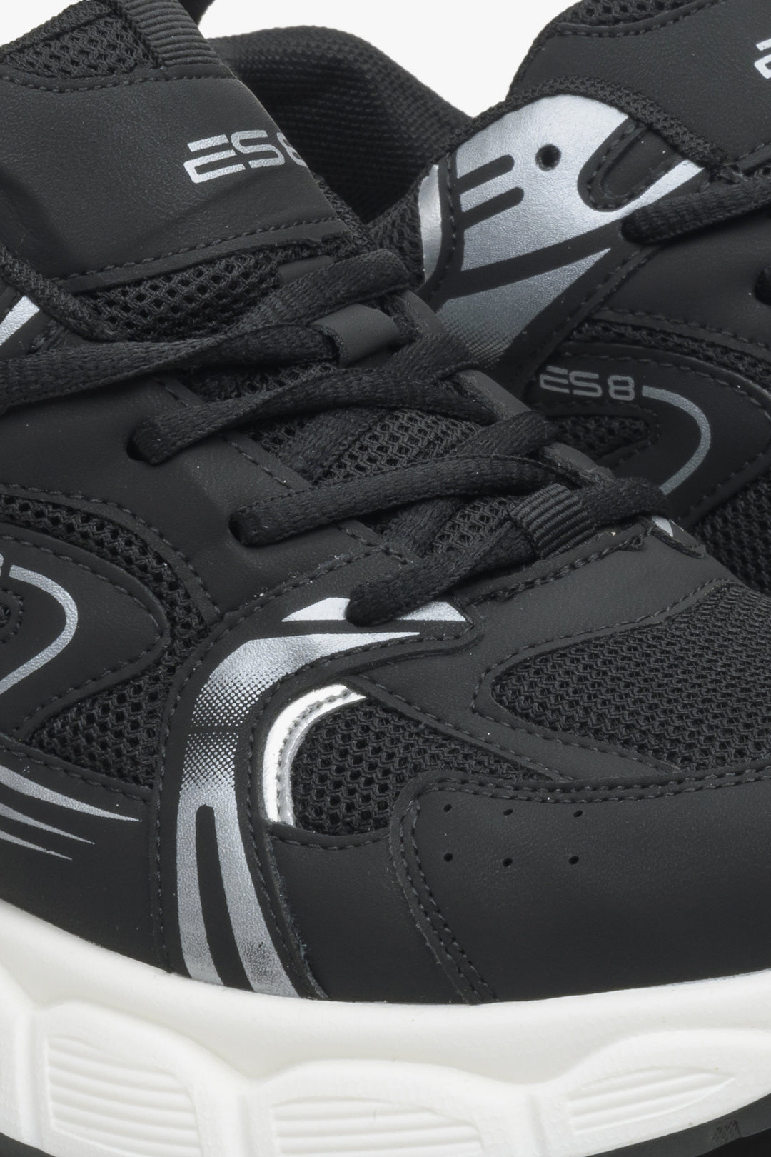 Women's black sneakers with silver details ES 8 - close-up on the seam line.