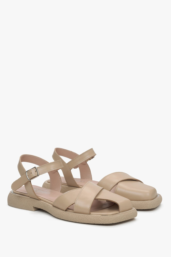 Beige leather sandals with criss-cross straps by Estro.