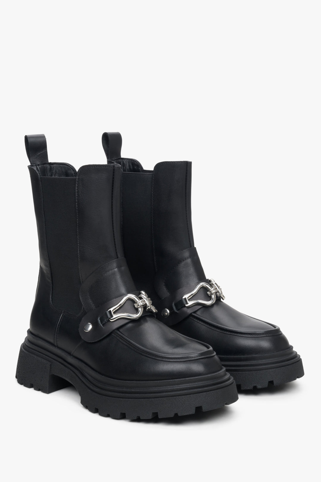 Black leather Chelsea boots by Estro with decorative embellishment.