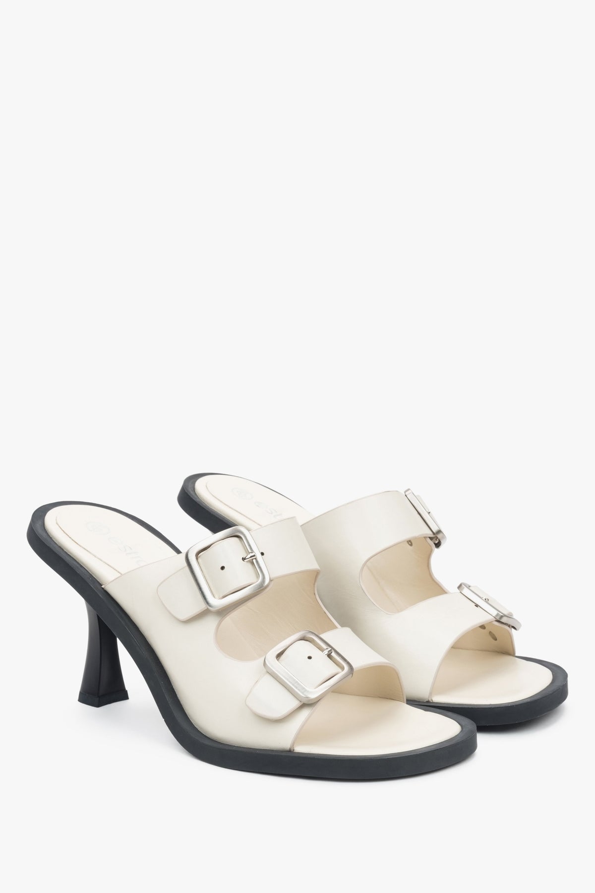 Leather, women's white  mules with a buckle from Estro - presentation of the tip and side of the footwear.