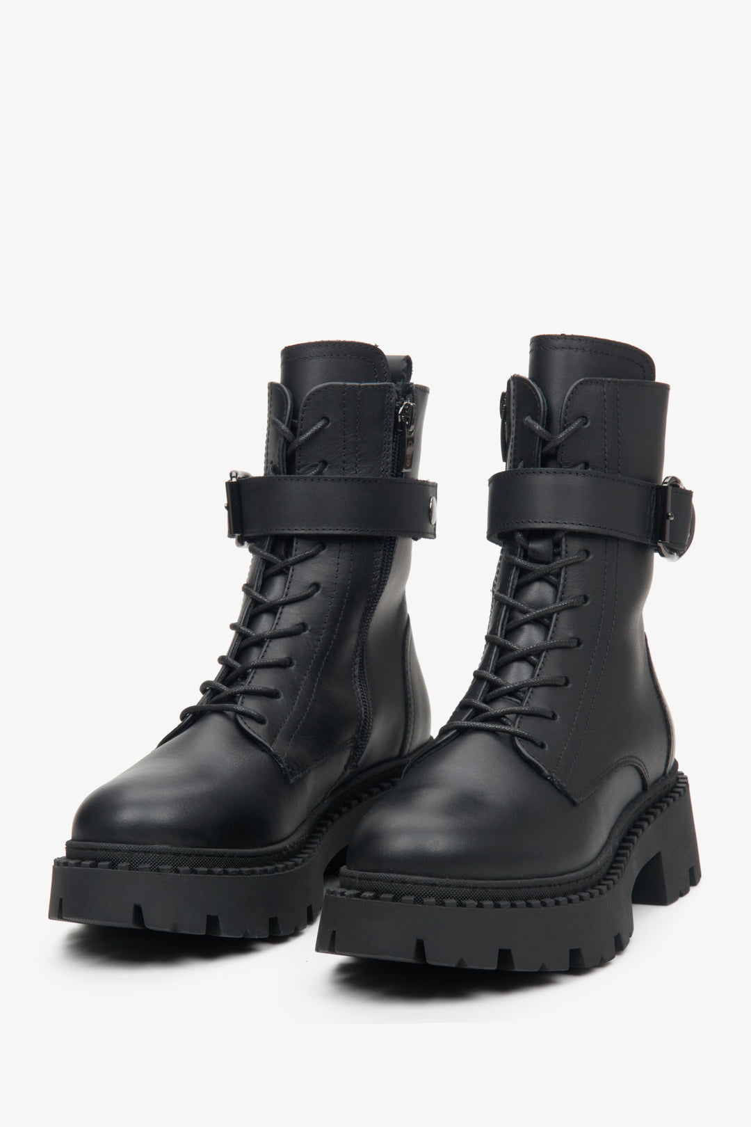 Leather, black Estro women's winter boots with a decorative strap - close-up on the toe.