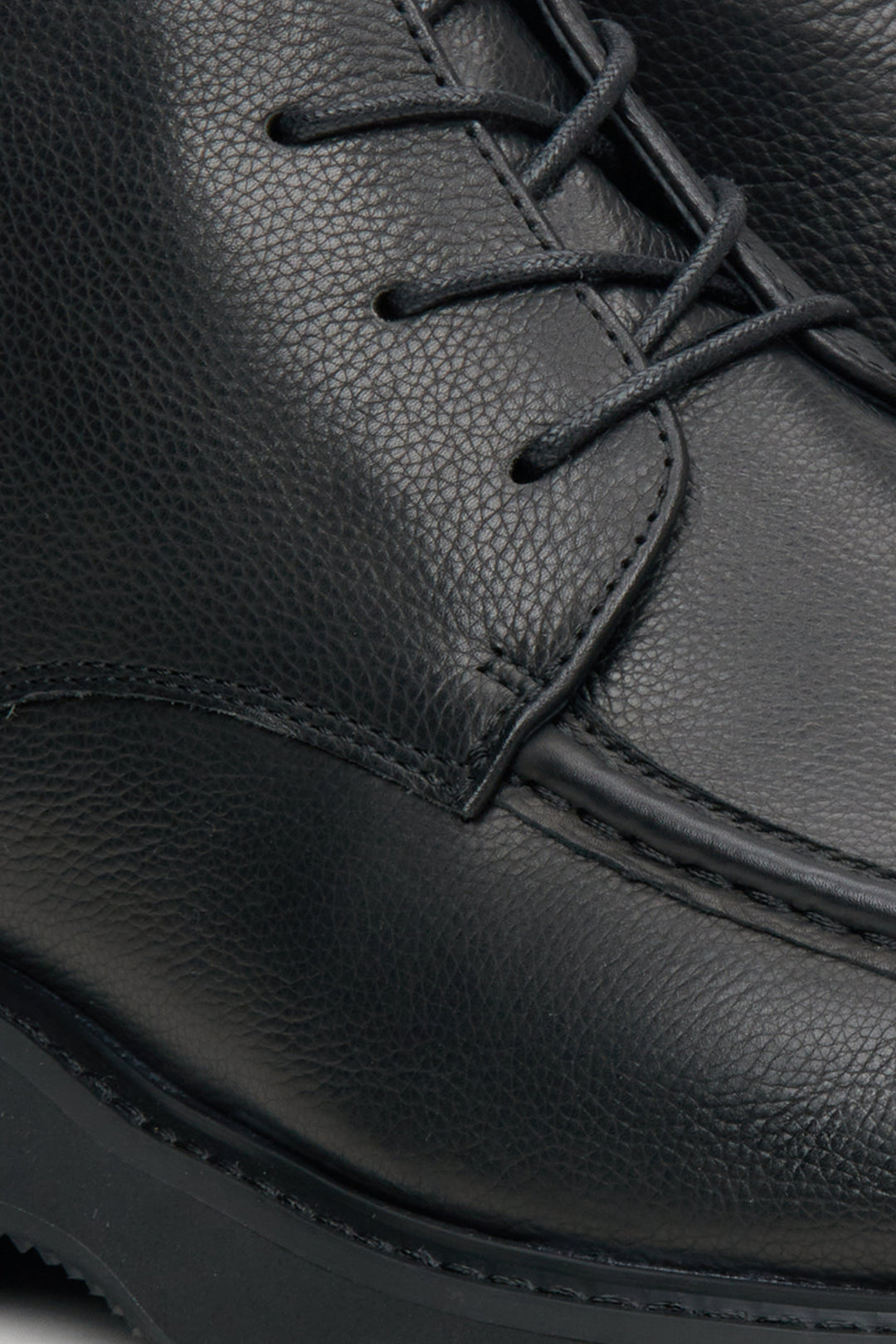 Men's black leather boots by Estro - close-up on the seam line.Black leather men's boots by Estro - close-up on the seam line.