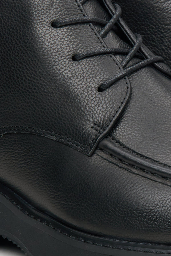 Men's black leather boots by Estro - close-up on the seam line.Black leather men's boots by Estro - close-up on the seam line.