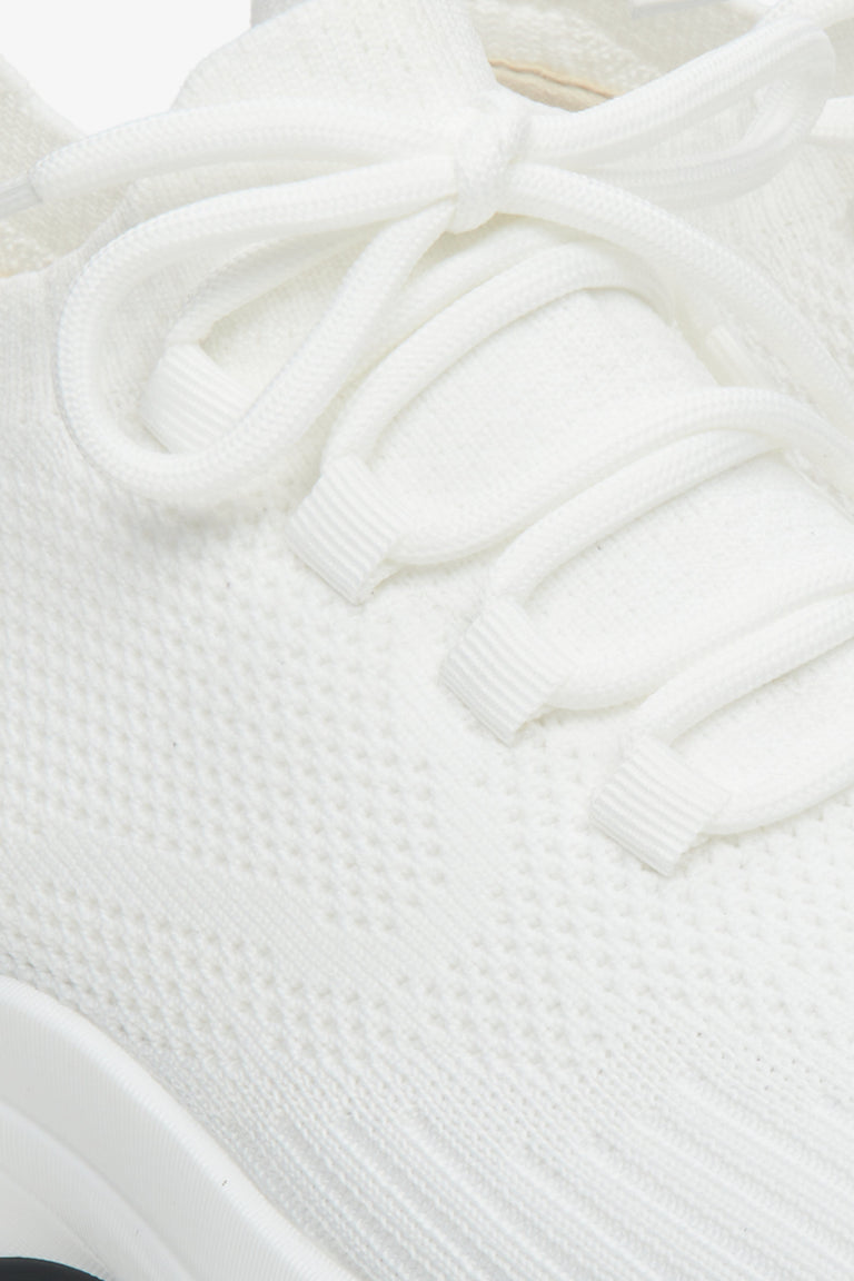 White women's mesh sneakers on elastic sole - a close-up on details.