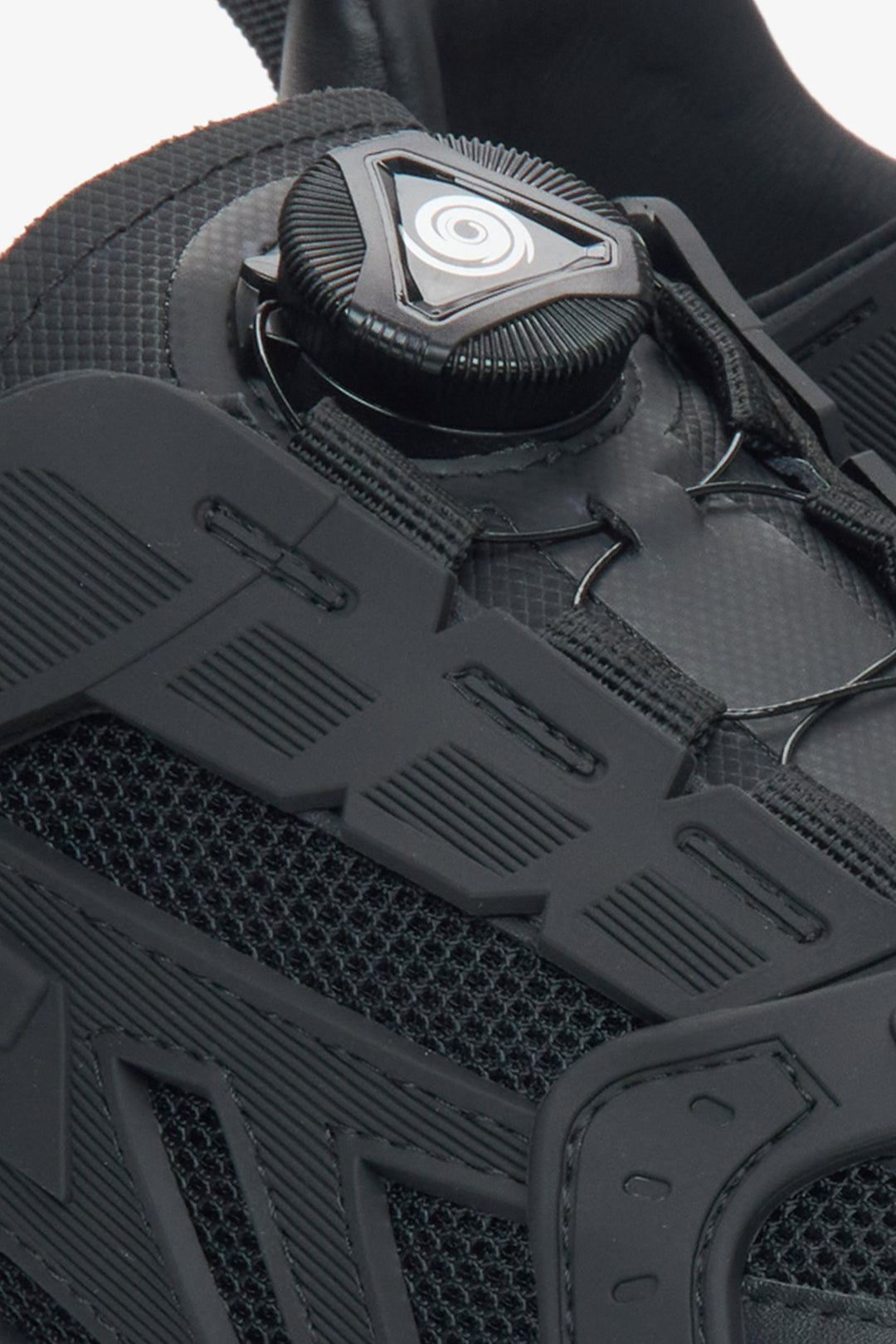 Black women's sneakers made of natural leather – close-up of the lacing system.