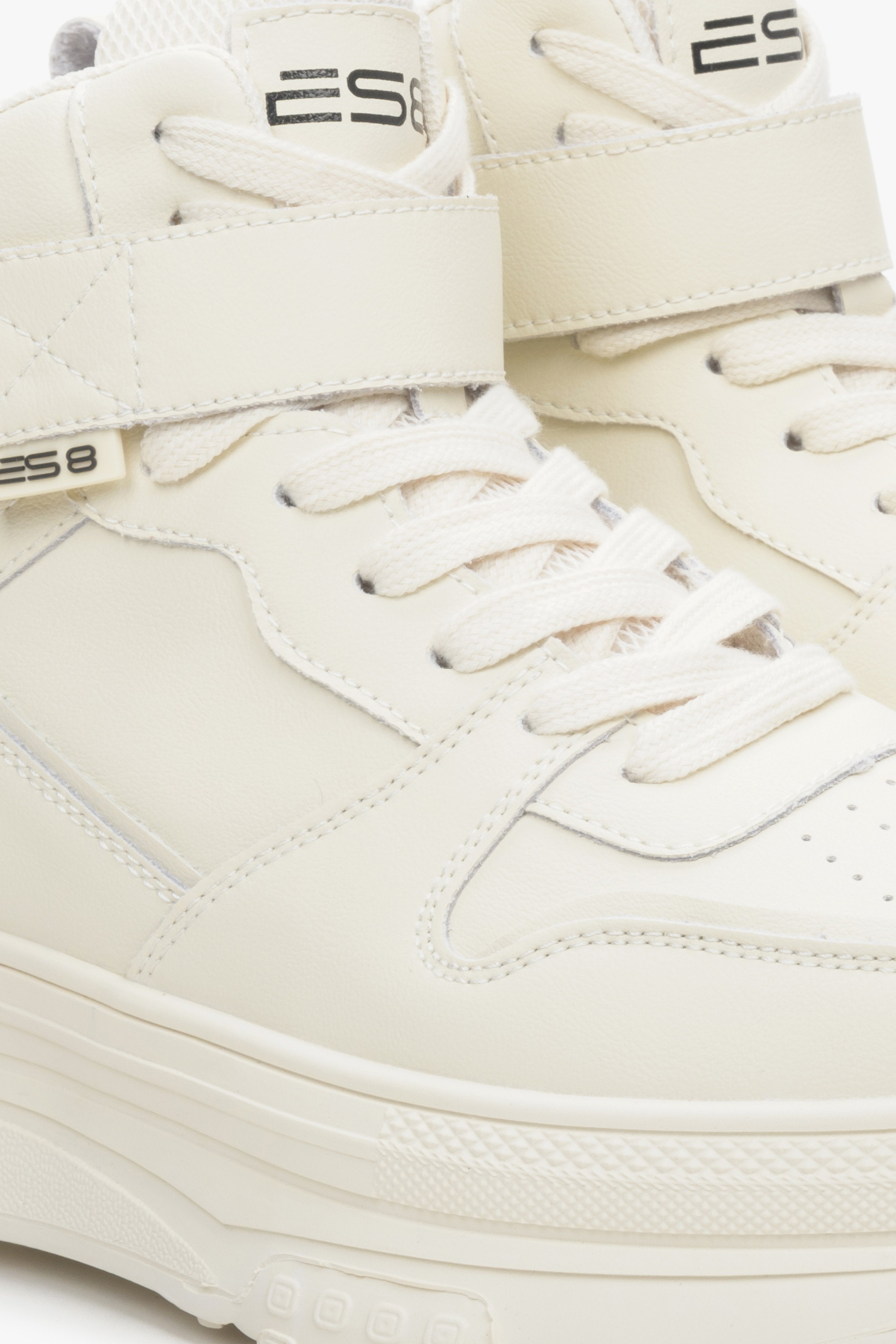 High-top women's sneakers ES8 made of genuine leather in light beige color - close-up on details.