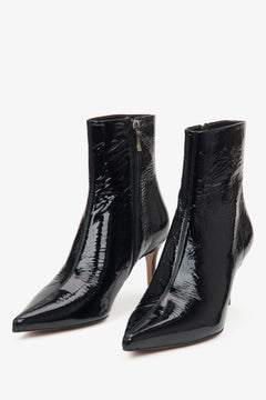 Black patent leather women's ankle boots on a stiletto heel by Estro – close-up of the toe of the shoe.