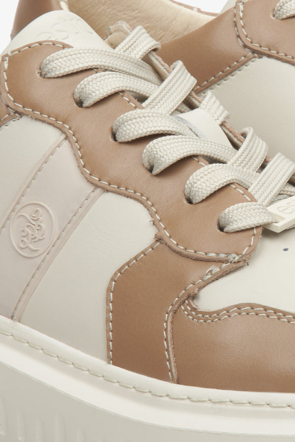 Leather women's Estro sneakers with laces on a flexible sole, beige & brown - close-up on the details.