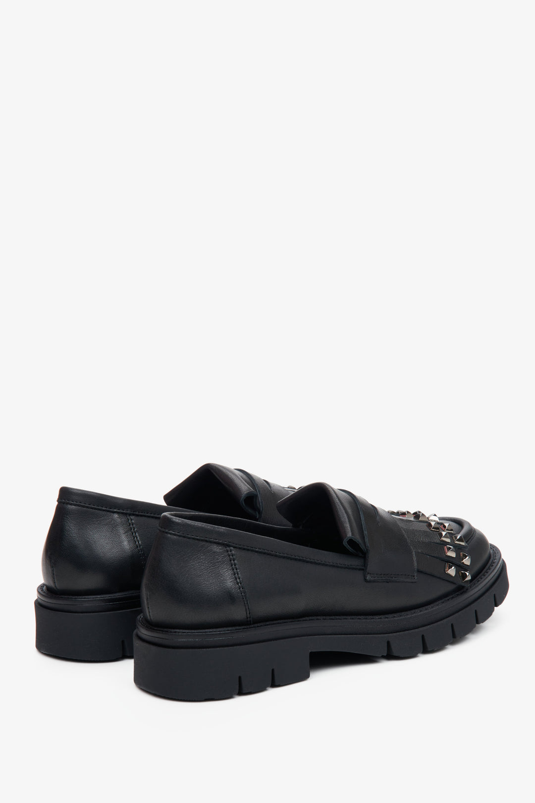 Women's black Estro moccasins - close-up on the heel and side line of the shoe.