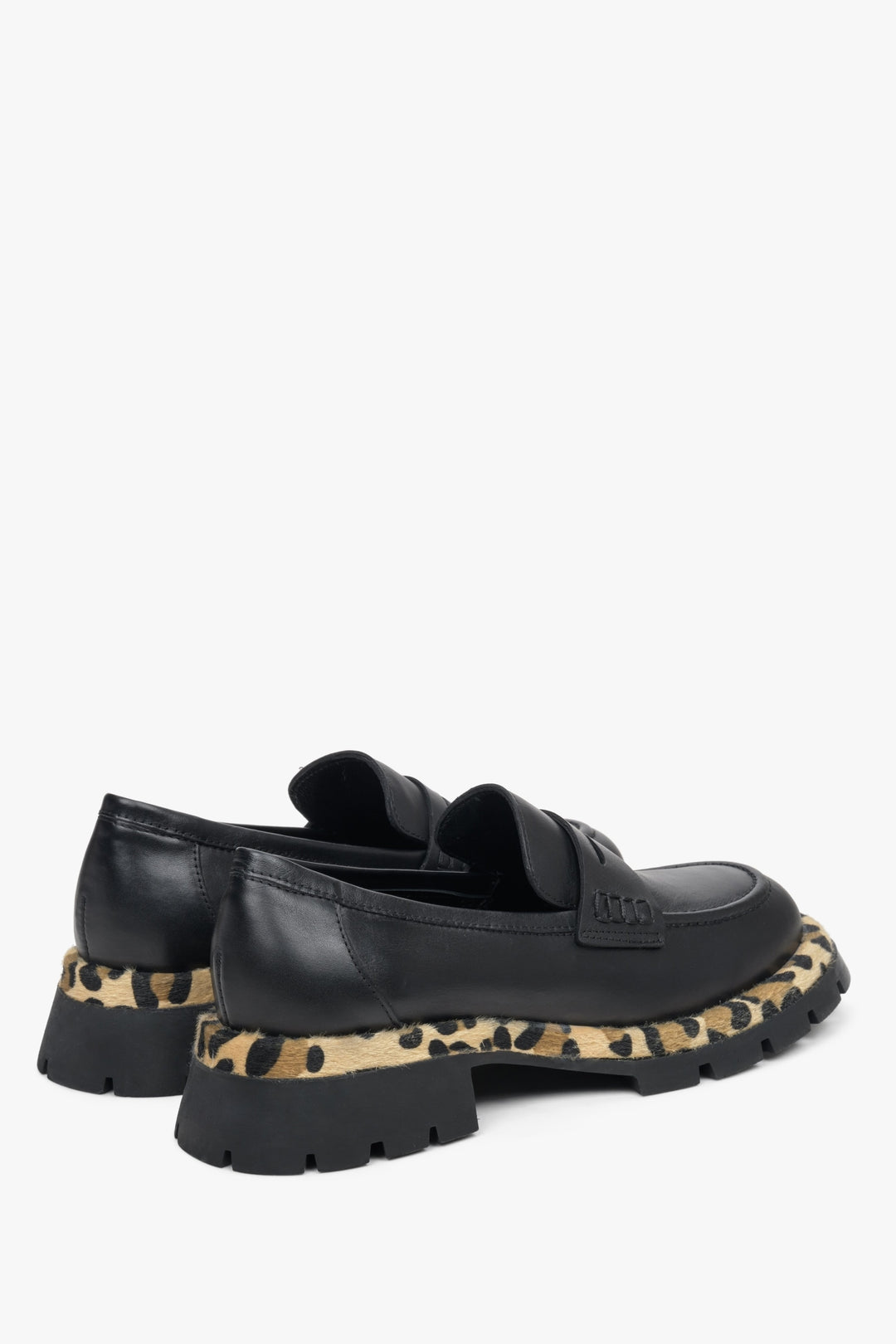 Women's black Estro  leather moccasins with a panther print - close-up on the heel and side line.