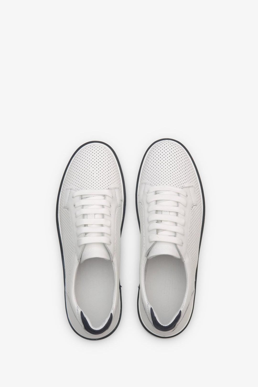 Men's leather sneakers for summer in white color with perforation - presentation of shoes from above.