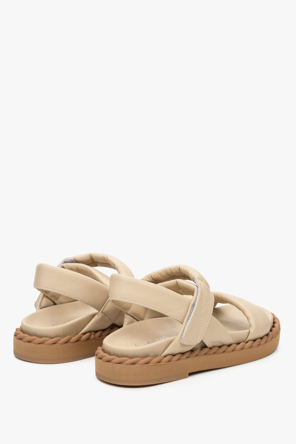 Women's beige flat sandals for summer on a comfortable, flexible sole - the presentation of the back and side of the shoes.