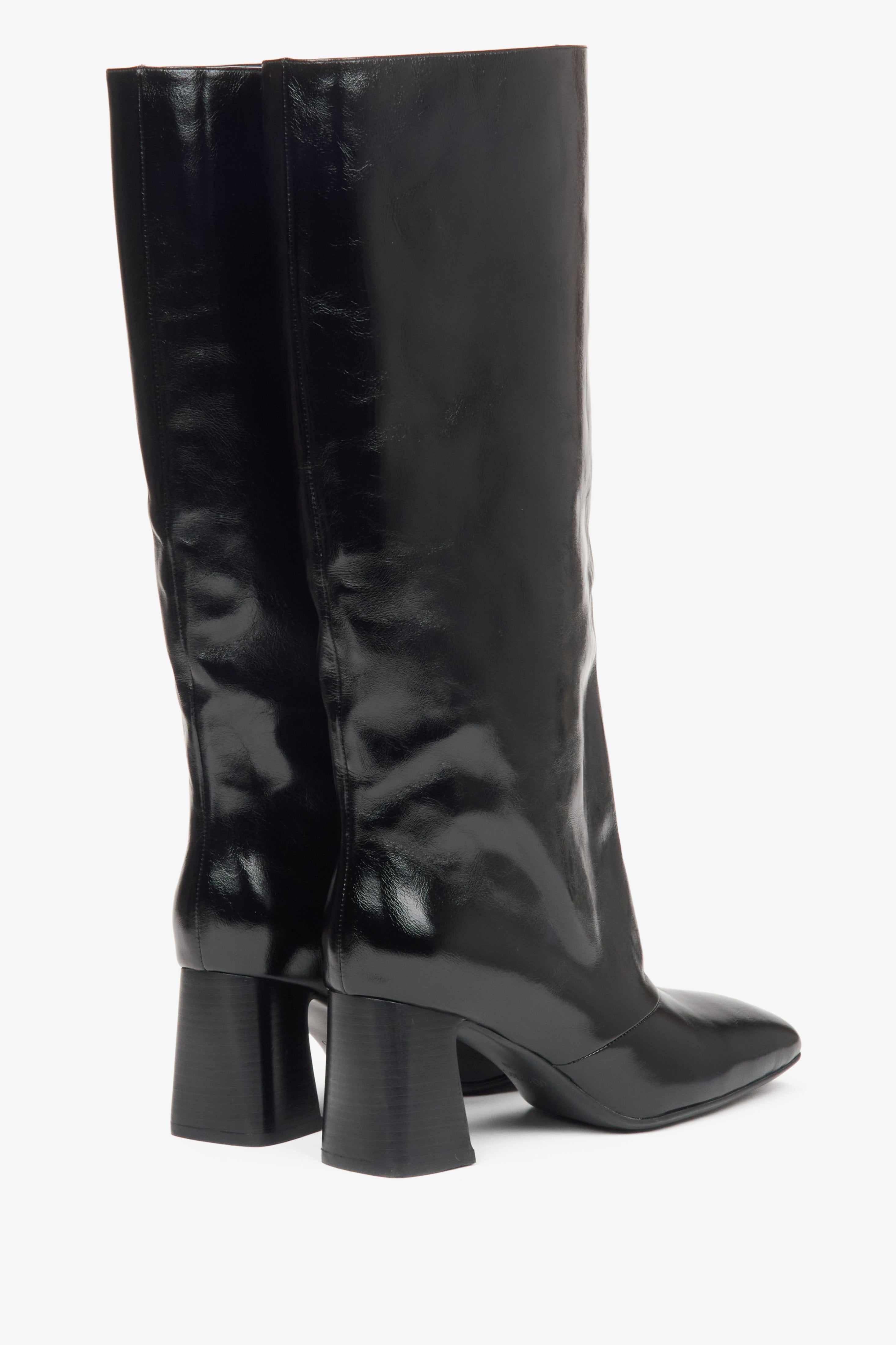 Black patent leather women's knee-high boots with a wide shaft and a block heel by Estro - close-up of the back and heel line.