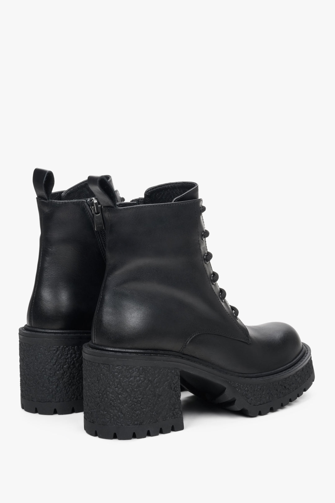 Black women's leather ankle boots with a heel - close-up of the lateral sidewall and back of the shoe.