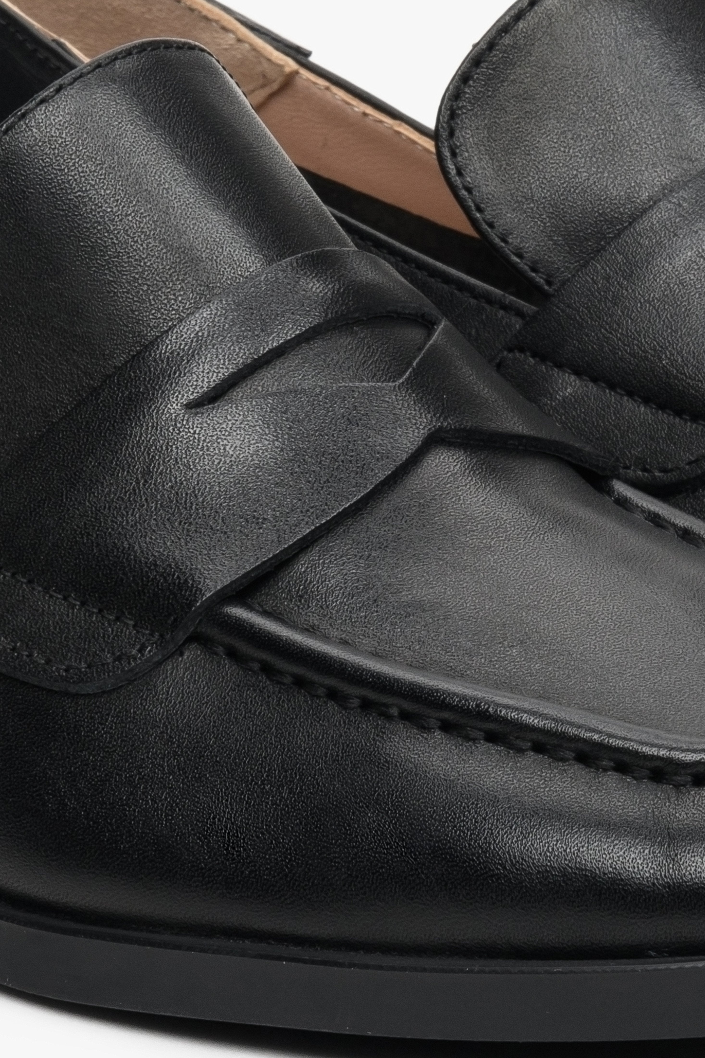 Women's black leather loafers by Estro - close-up on the stitching pattern.