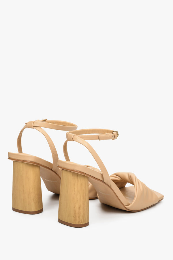 Women's beige leather sandals with a block heel - close-up on the heel.