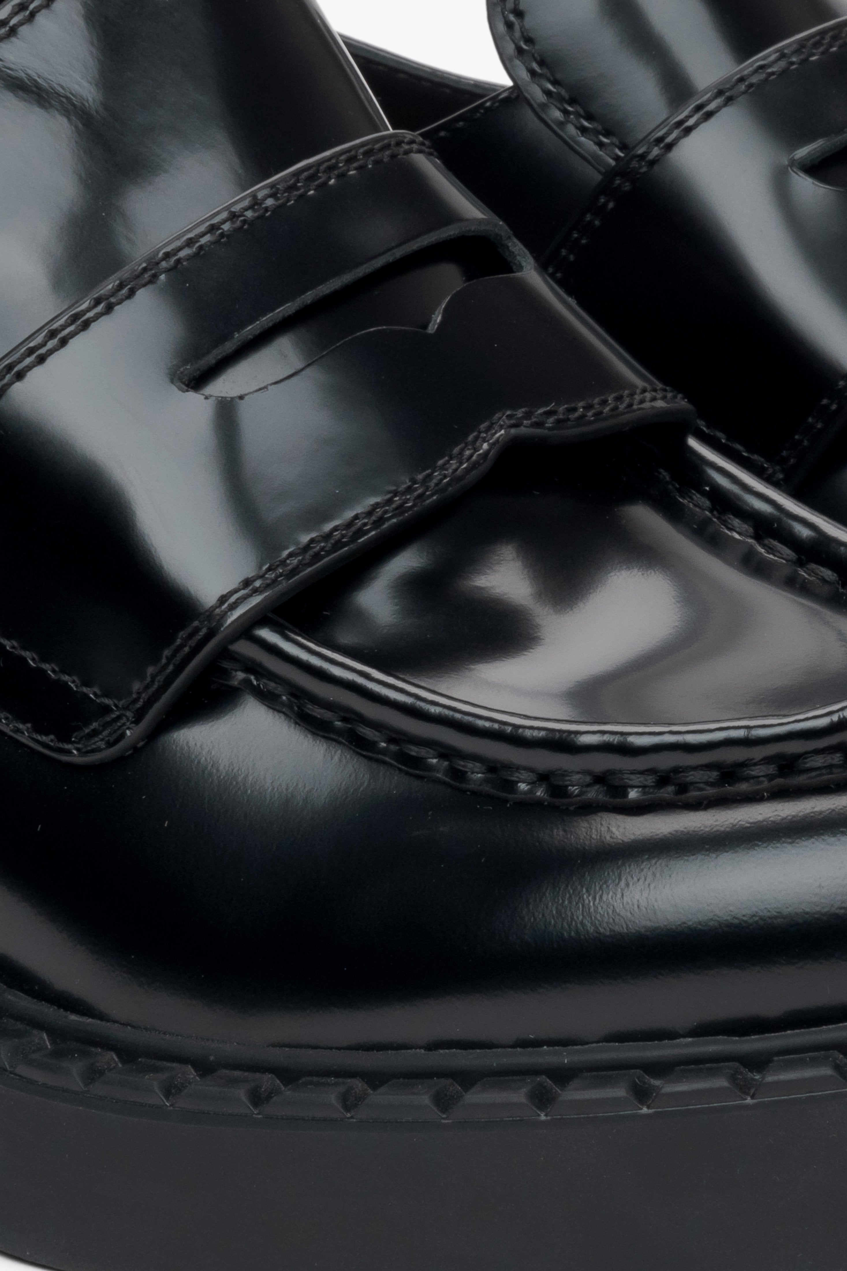 Women's black leather penny loafers - close-up of the details.