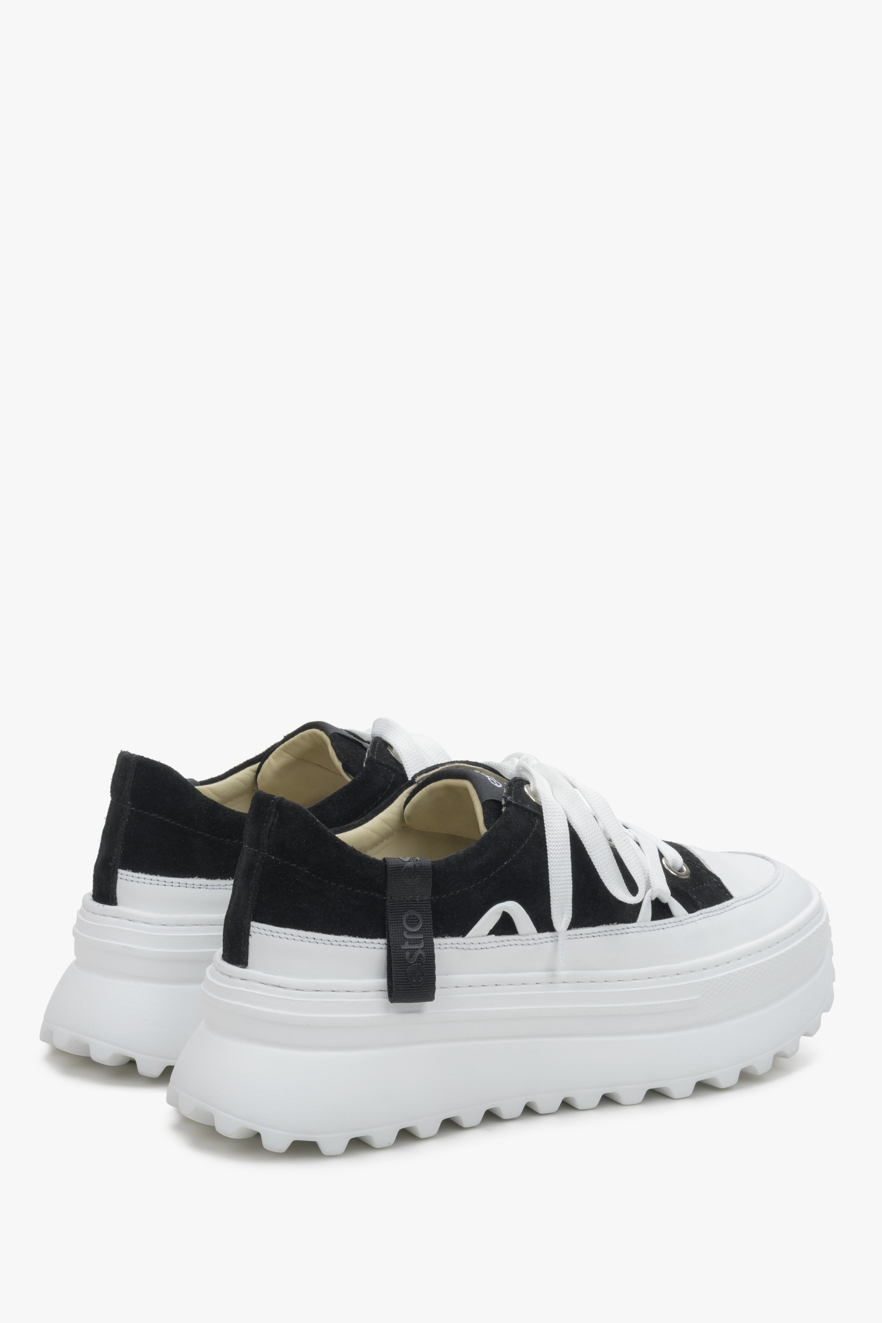 Women's Estro white and black sneakers - close-up on the side line and heel of the shoes.