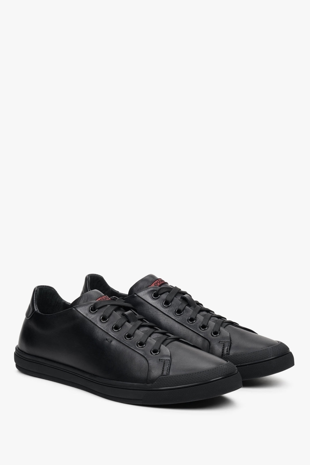 Men's black Estro sneakers with genuine leather laces - close-up of the side seam and the toe of the shoe.