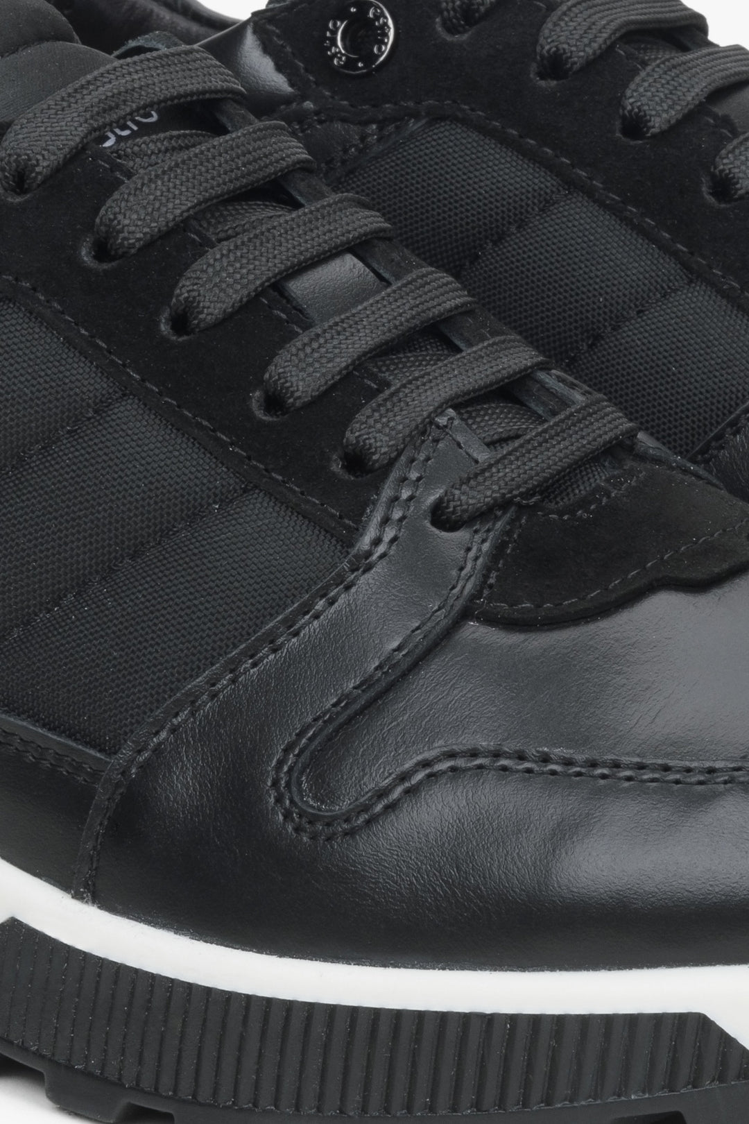 Men's black sneakers by Estro - close-up on the details.