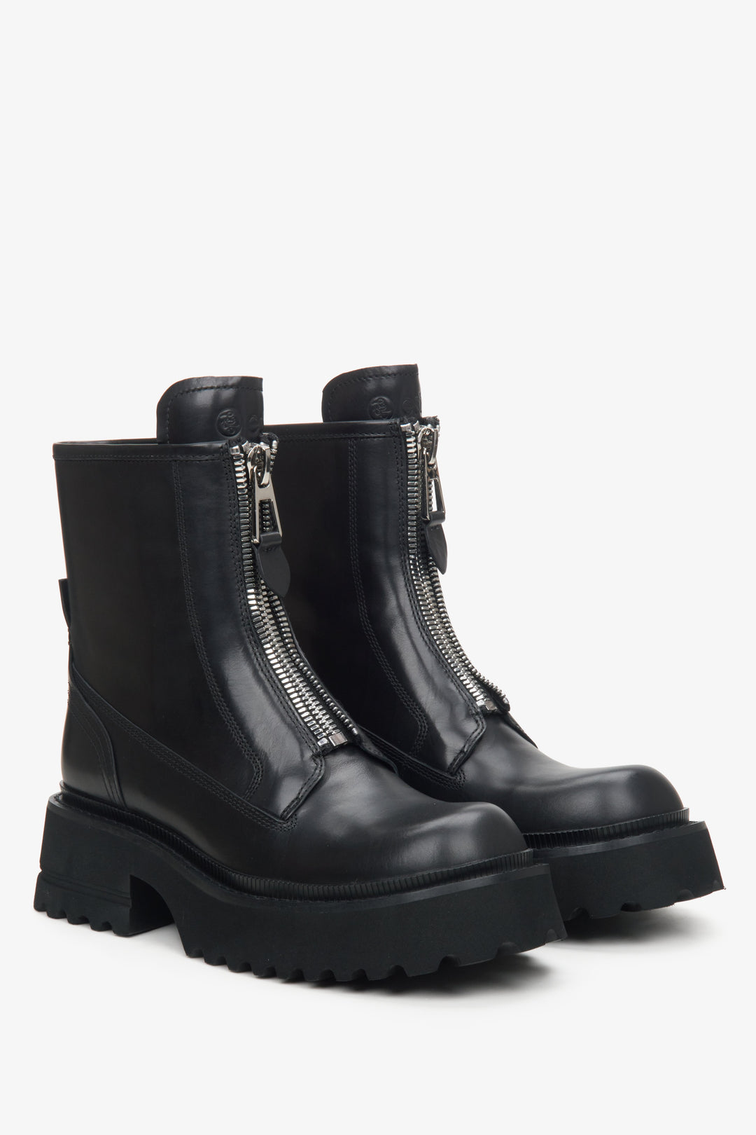 Black leather boots with a decorative zipper by Estro.