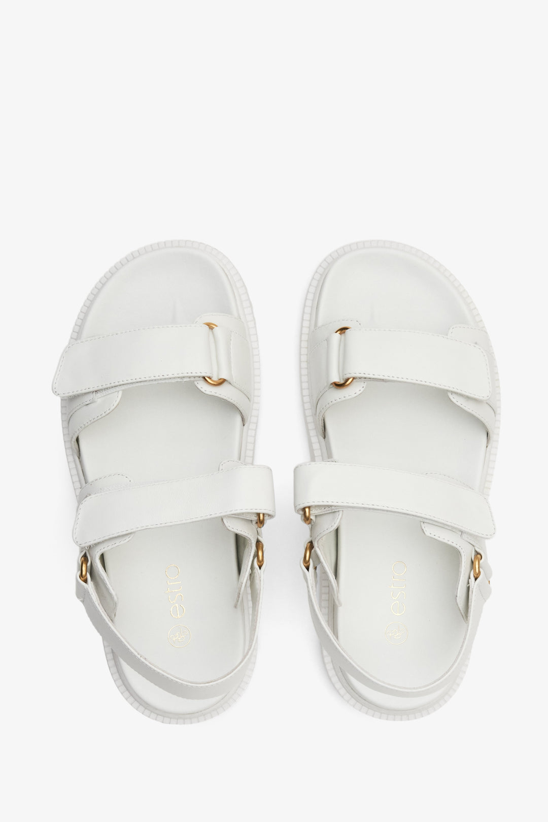 Women's white sandals made of genuine leather with a flexible sole and golden elements.