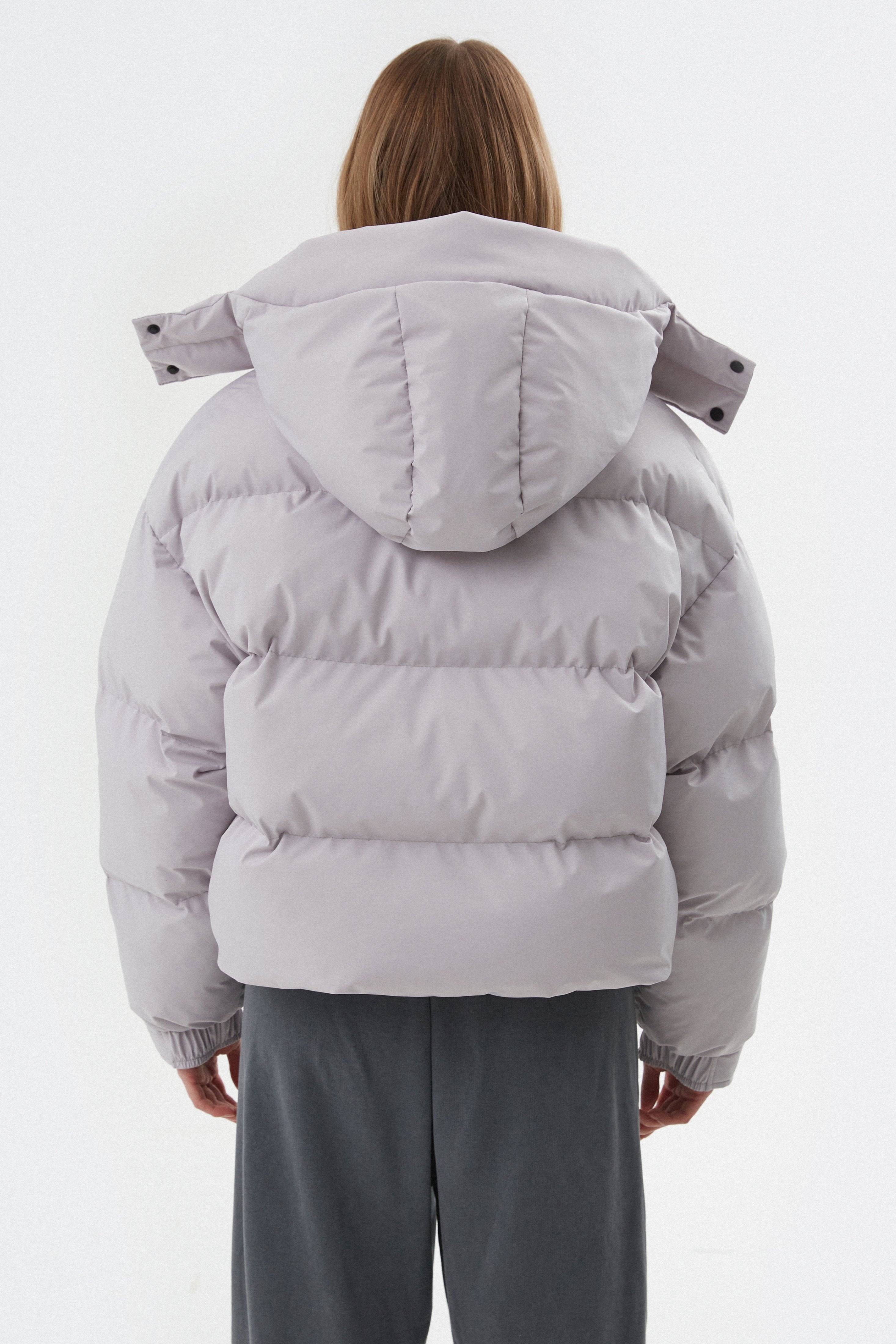 Grey women's puffer jacket by Estro - back view.