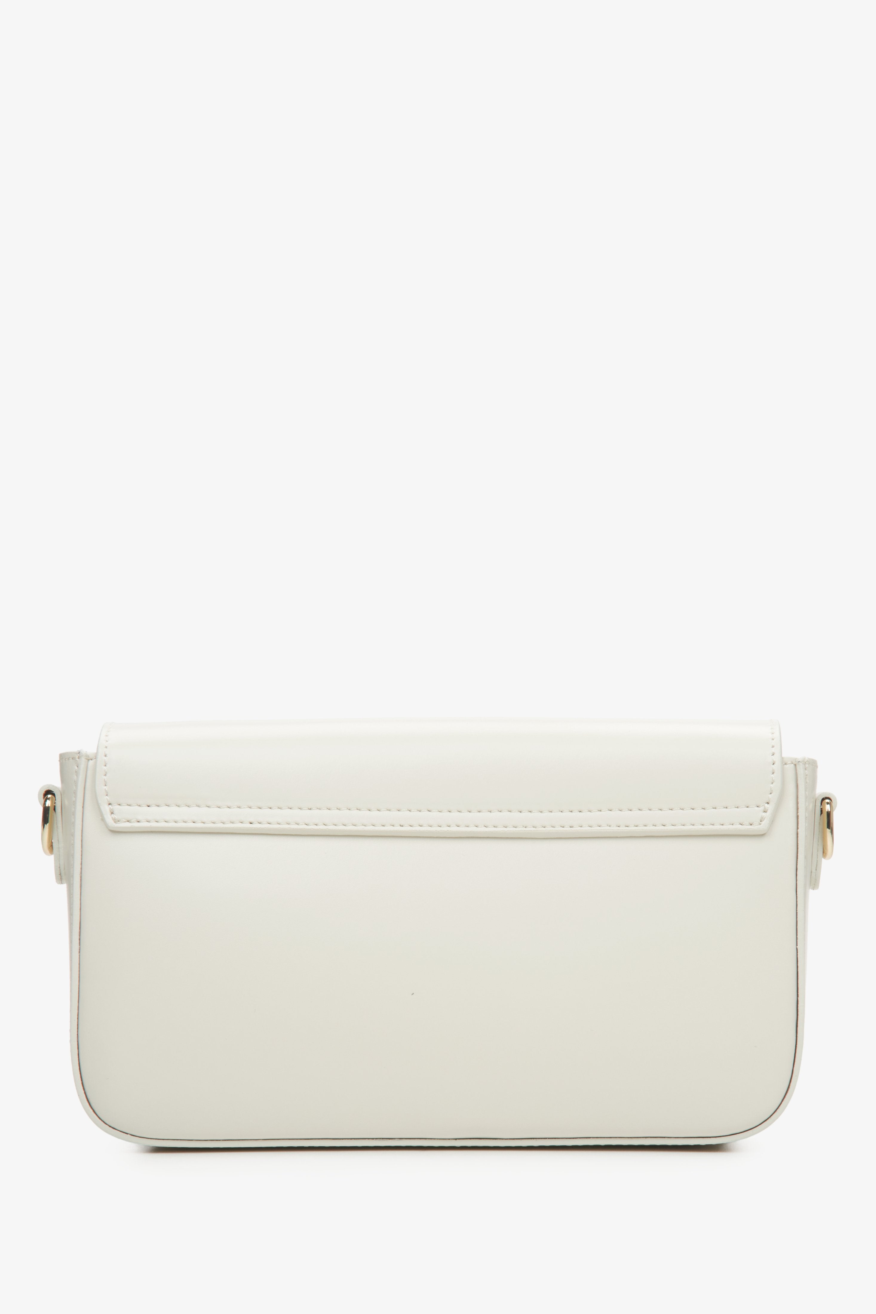 Small women's handbag in milky-beige, styled as a baguette.