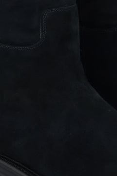 Velour knee-high boots for winter in black - a close-up on details.