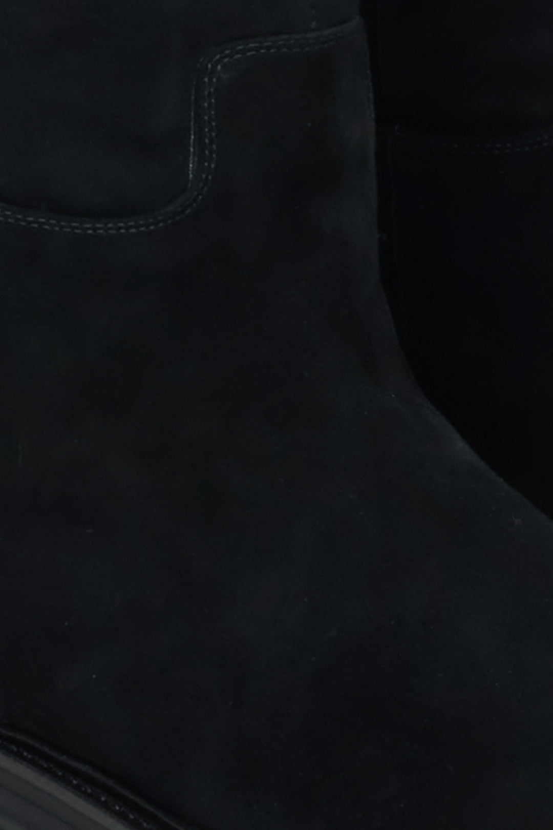 Velour knee-high boots for winter in black - a close-up on details.