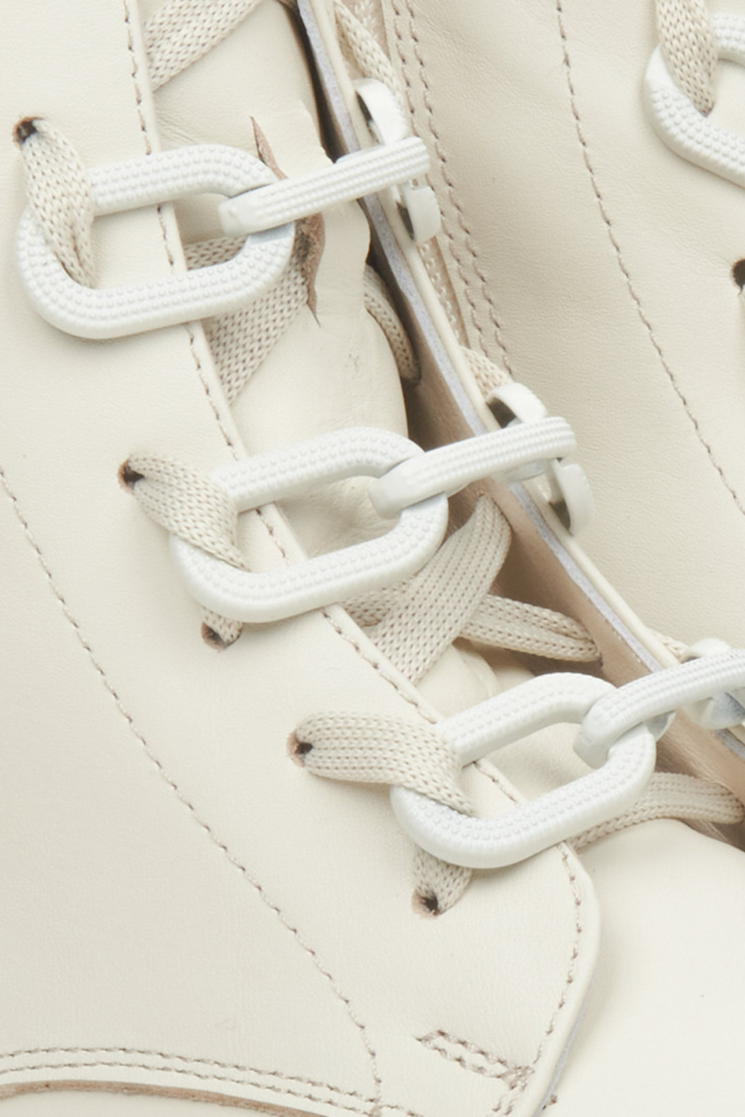 Women's light beige leather insulated ankle boots - a close-upon details.
