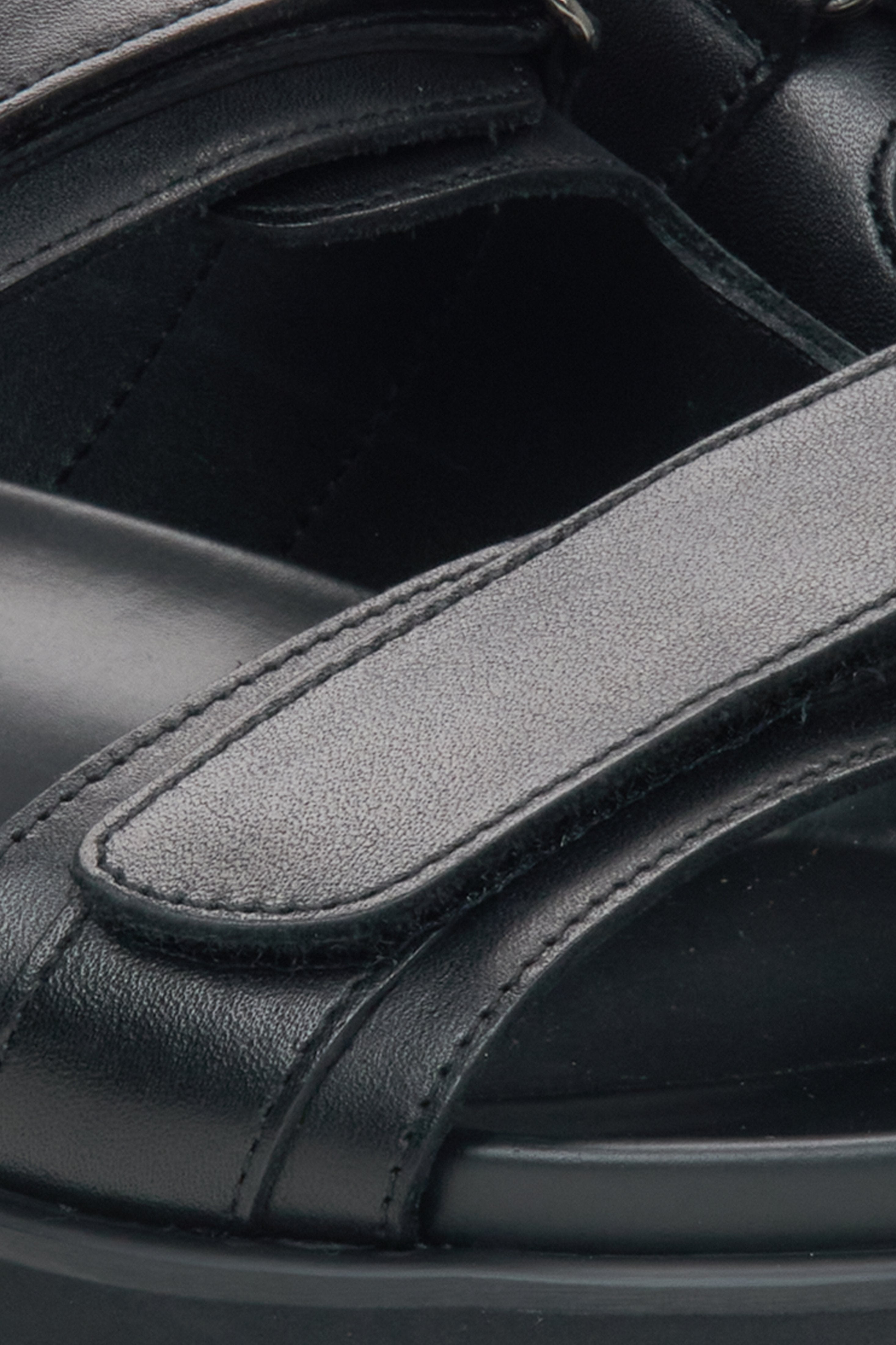 Men's black sandals - close-up detail.