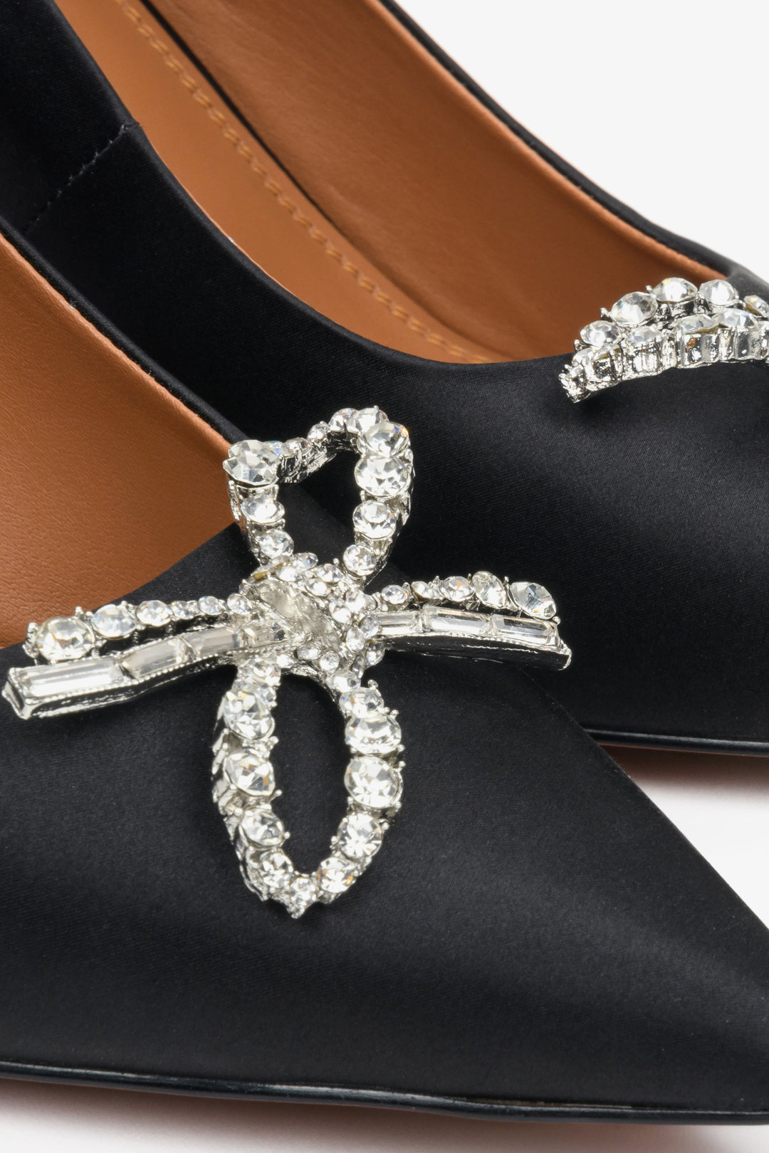 Women's high black heels by Estro with embellishment - close-up on the decoration.