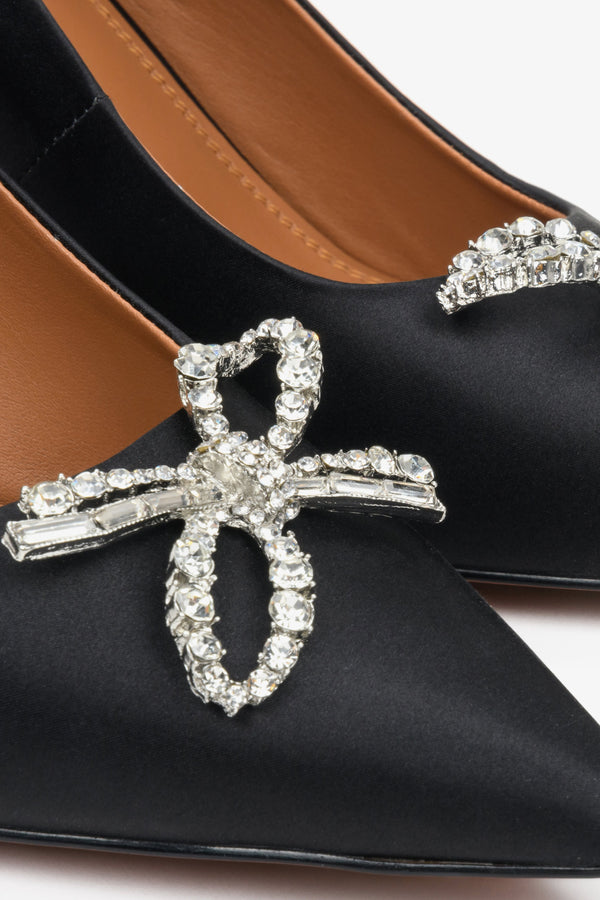 Women's high black heels by Estro with embellishment - close-up on the decoration.