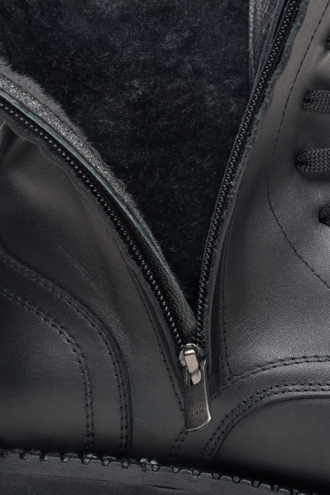 Women's boots with decorative lacing in black - close-up on the soft interior.