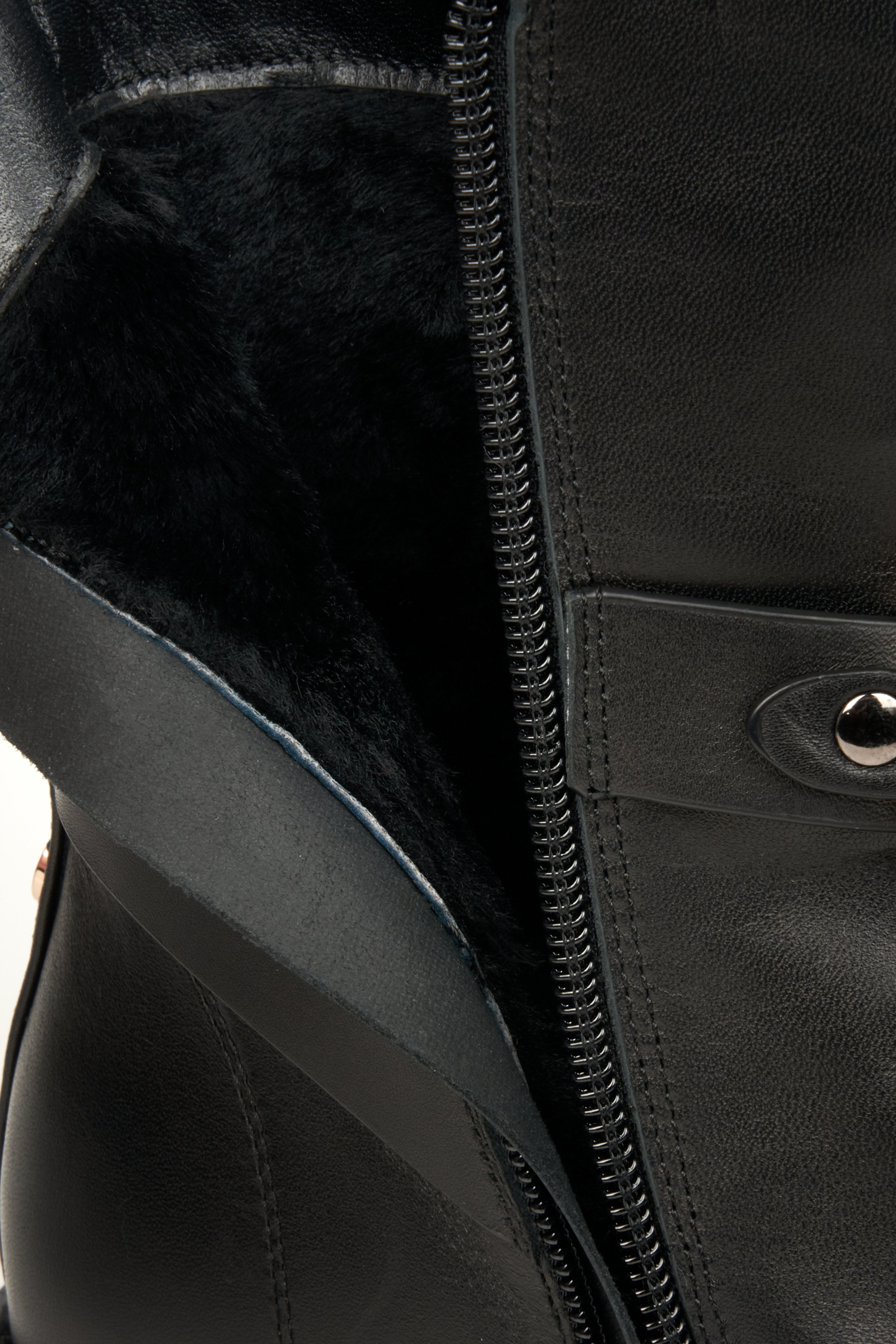 Women's black winter boots in natural leather - close-up on the warm boot lining.