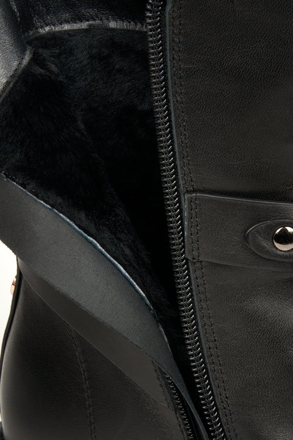 Women's black winter boots in natural leather - close-up on the warm boot lining.