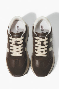 Pair of brown sneakers with white laces.