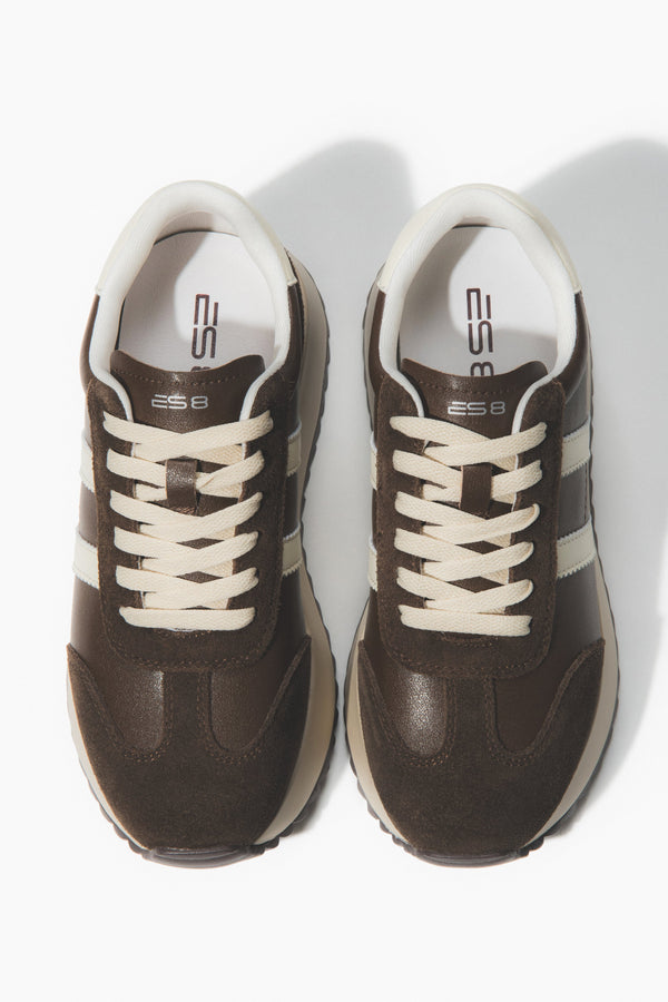 Pair of brown sneakers with white laces.