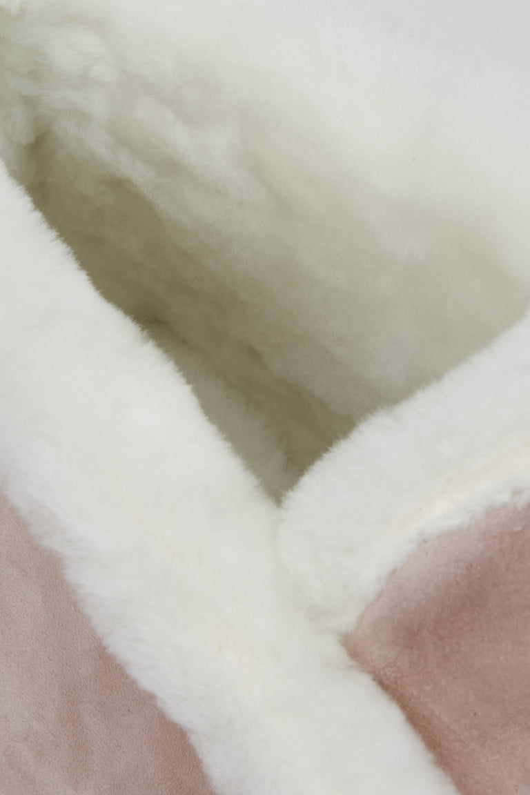 Winter women's moccasins in pink - close-up on the warm, furry lining.