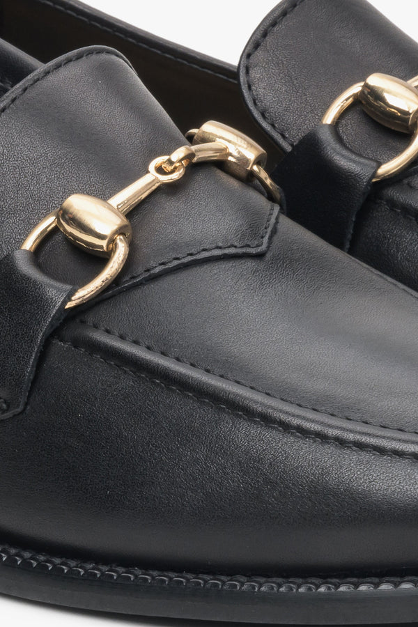 Elegant, black women's loafers made of Italian leather - close-up on details.